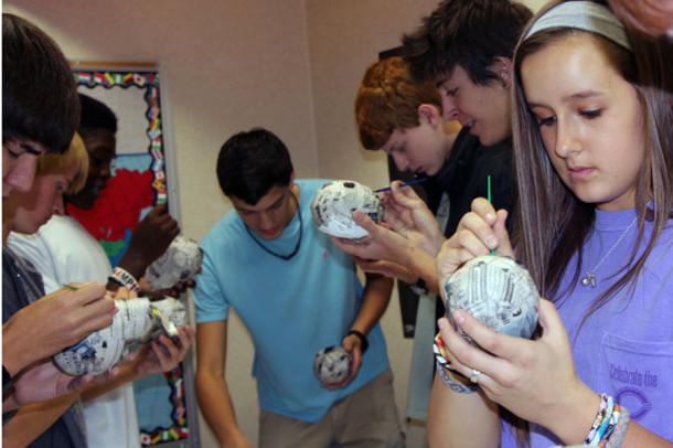 Students in Mrs. Perez’s room create paper skulls for the Spanish holiday, “The Day of the Dead.”  