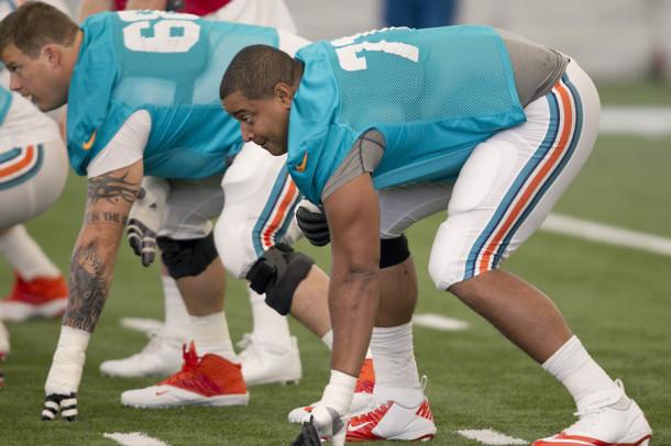 Tackle Jonathan Martin, right, in his stance before ball is snapped during Miami Dolphins practice at the Dolphins training facility at NSU in Davie, Florida, Tuesday, July 23, 2013.