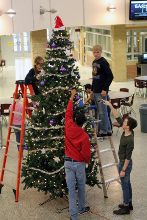 Members of the CHS Super Team decorate the Christmas tree in the center of the lower commons. 