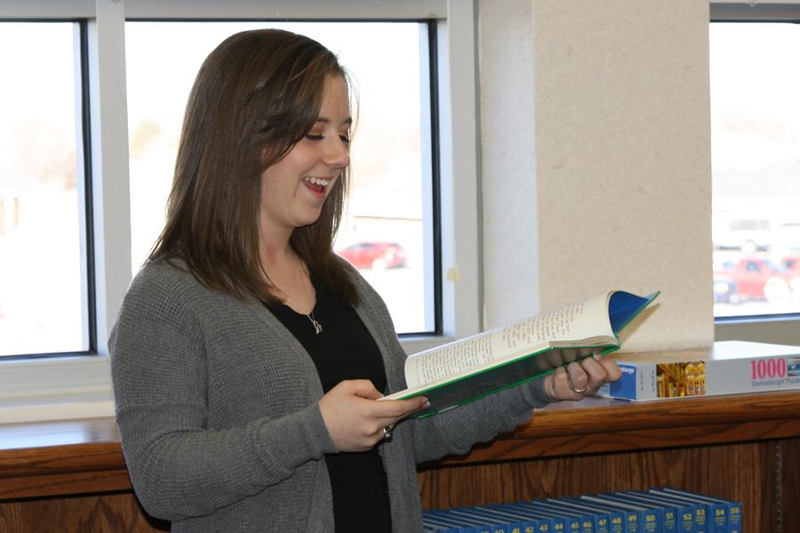 Part of senior Lindsay Teweleit’s responsibilities at CASP (Canyon After School Program) is to read to the children.