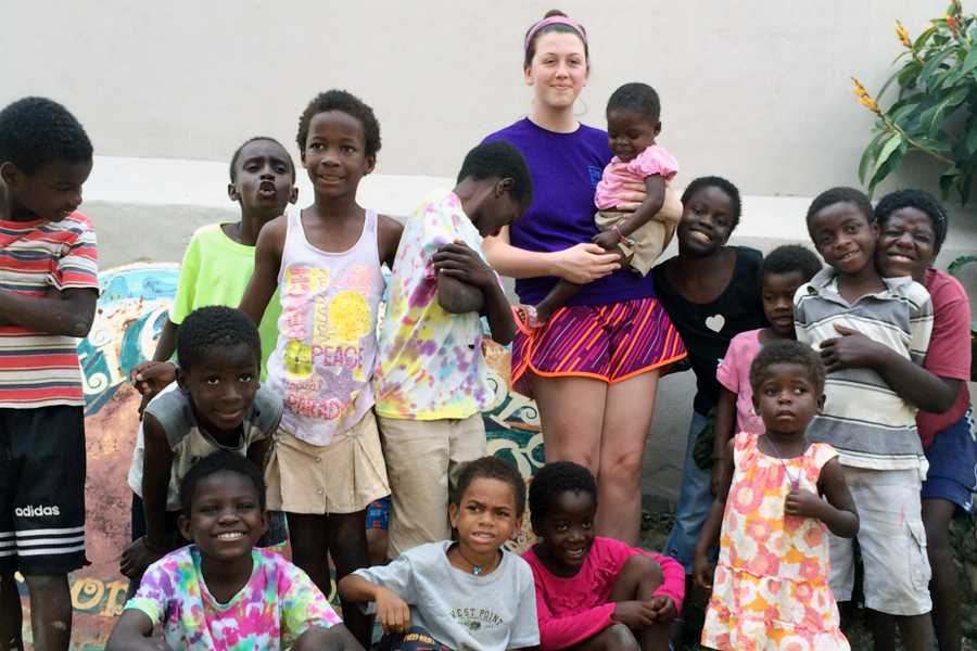 Senior Mackenzie Farmer works with children at an orphanage in Haiti during spring break.