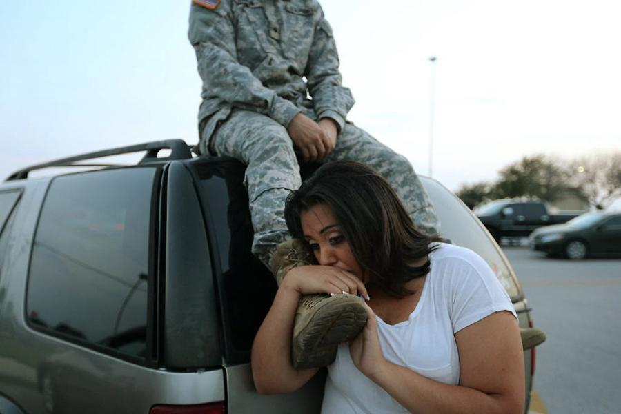 Lucy Hamlin and her husband, Spc. Timothy Hamlin, wait to get back to their home on the base following a shooting incident at Fort Hood, Texas, on Wednesday, April 2, 2014. 