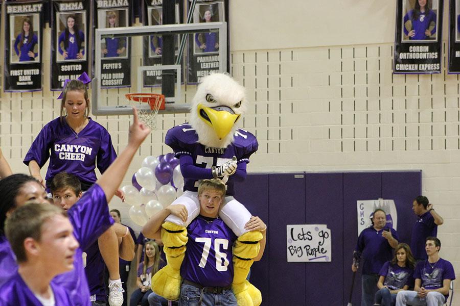 Senior Austin Slayton and mascot junior Austin Lackey join the cheerleaders in a chant at the pep rally. 