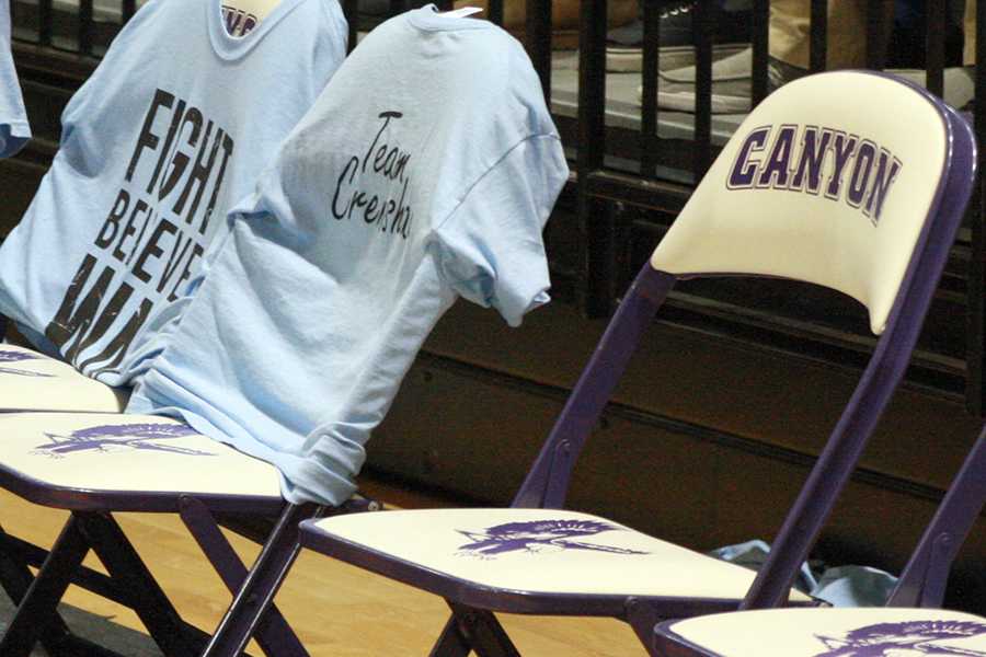 Team Crenshaw t-shirts drape chairs on the sideline of the Jan. 4, 2013 basketball game. Coach Jason Underwood plans to leave a chair empty to honor Guy Crenshaw this season.