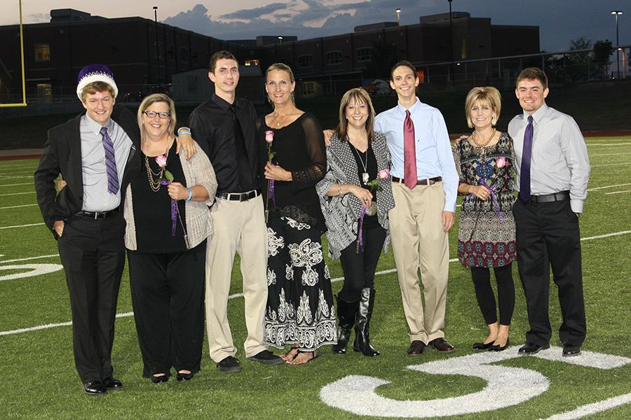 Homecoming king Ty Crenshaw and his mother, Debbie Crenshaw; Aaron Hughes and mother Christie Shippy; Stacy Glenn with son Trevor Glenn; and Karla McCallie with son Cade McCallie gather after the announcement during the powder puff game.