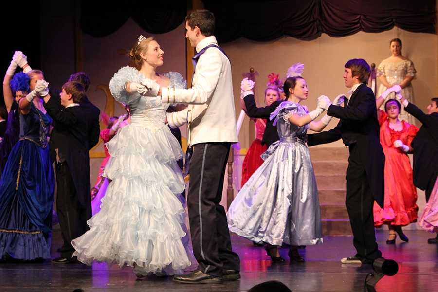 Bailey DeBerry, as Cinderella, dances with Aaron Hughes, as Prince Charming, in a dress rehearsal for Cinderella at Canyon High School.