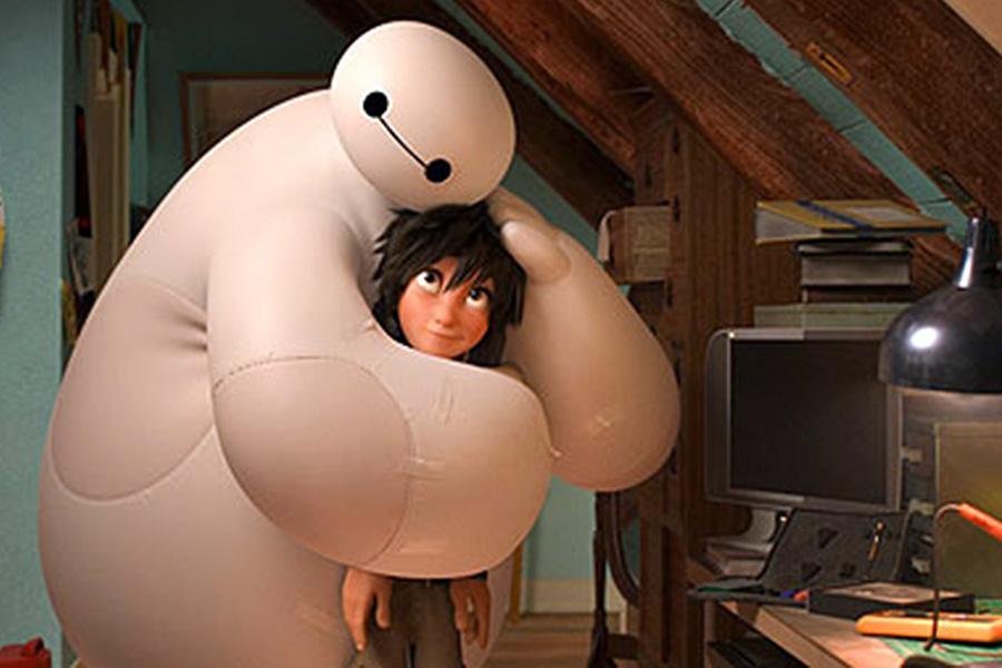 Young scientist Hiro Hamada (voiced by Ryan Potter) and health care robot Baymax (Scott Adsit) hug in a scene from Disney’s new film, Big Hero 6. 