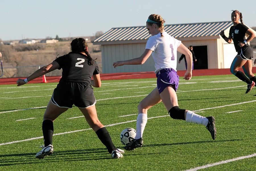 Junior Brittany Gregory shields the ball from a Randall player Feb. 6 at a home game. 