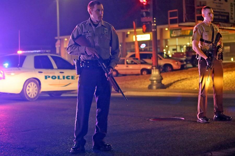 Police guard the corner off Adams Street and South Florissant Rd after two officers were shot while standing guard in front of the Ferguson Police Station on Thursday, March 12, 2015 in Ferguson, Mo. 