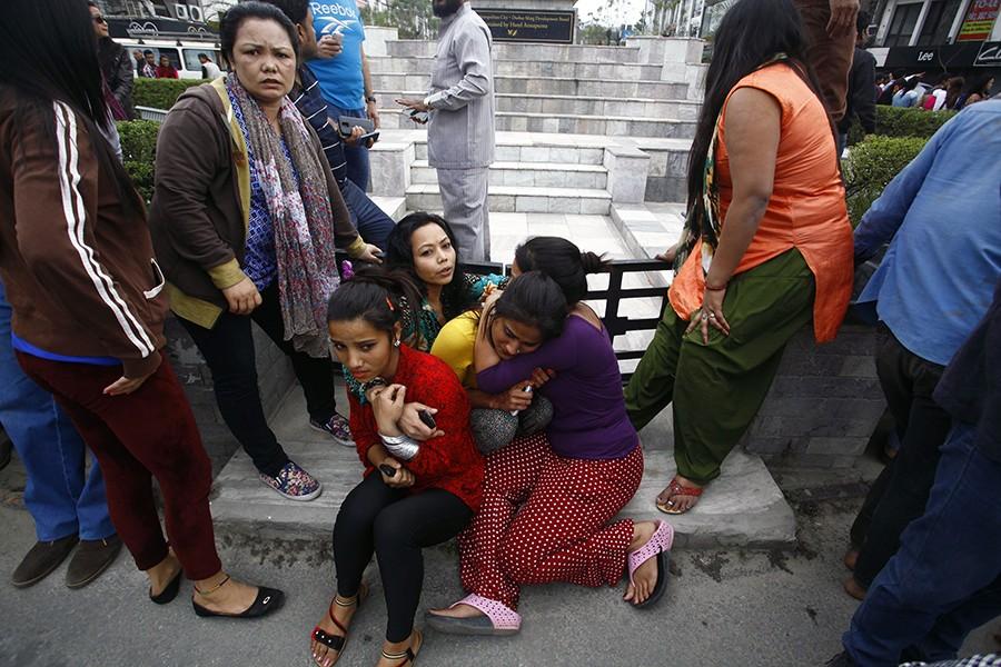 People embrace each other after a 7.8-magnitude earthquake rocked Kathmandu, Nepal, on Saturday, April 25, 2015.