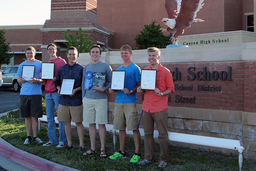 Members of Student Council hold up the awards they received in the mail from the Texas Association of Student Councils.