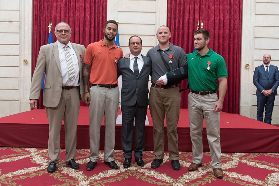 French President Francois Hollande, center, poses with British man Chris Norman, from left, and Americans Anthony Sadler, Spencer Stone and Alek Skarlatos during a ceremony at the Elysee Palace in Paris on Monday, Aug. 24, 2015. The four men were awarded the Legion of Honor medal for bravery after preventing a possible terrorist attack aboard a Thalys high-speed train en route to Paris from Amsterdam on Friday. (Witt-Messyasz/Abaca Press/TNS)