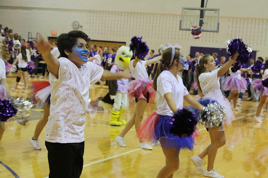 Quintanilla cheers at the 9/11 pep rally, participating in the red, white and blue theme with face paint.