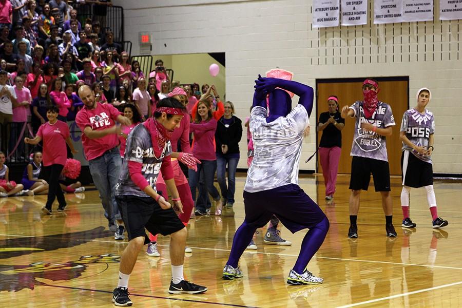 Senior Purple Posse leader Caysan Lytal performs during the pink out pep rally Oct. 2.