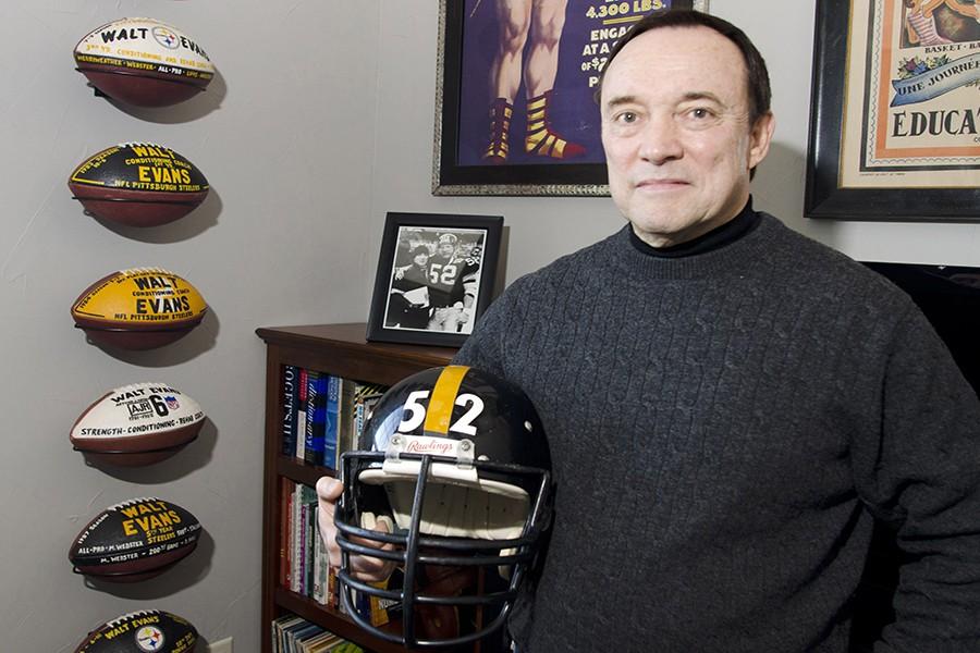 Walt Evans, former Strength and Conditioning coach for the Pittsburgh Steelers, stands in his Aledo, Texas, home with the football helmet and a picture of himself and former center for the team, Mike Webster, on December 19, 2015. Webster is part of the focus in the upcoming movie "Concussion," which opens on Christmas Day, and the NFL's handling of Chronic Traumatic Encephalopathy (CTE). (Bob Haynes/Fort Worth Star-Telegram/TNS)