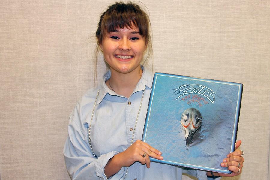 Senior Ryleigh Thompson holds the Eagles vinyl album Their Greatest Hits (1971-1975). The album can be purchased online and in local music stores.