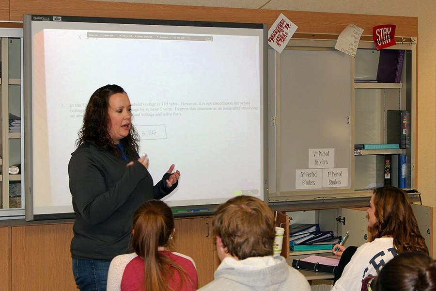 Math teacher Jessica Ray demonstrates to her students how to solve algebraic equations on the smart board in her classroom. 