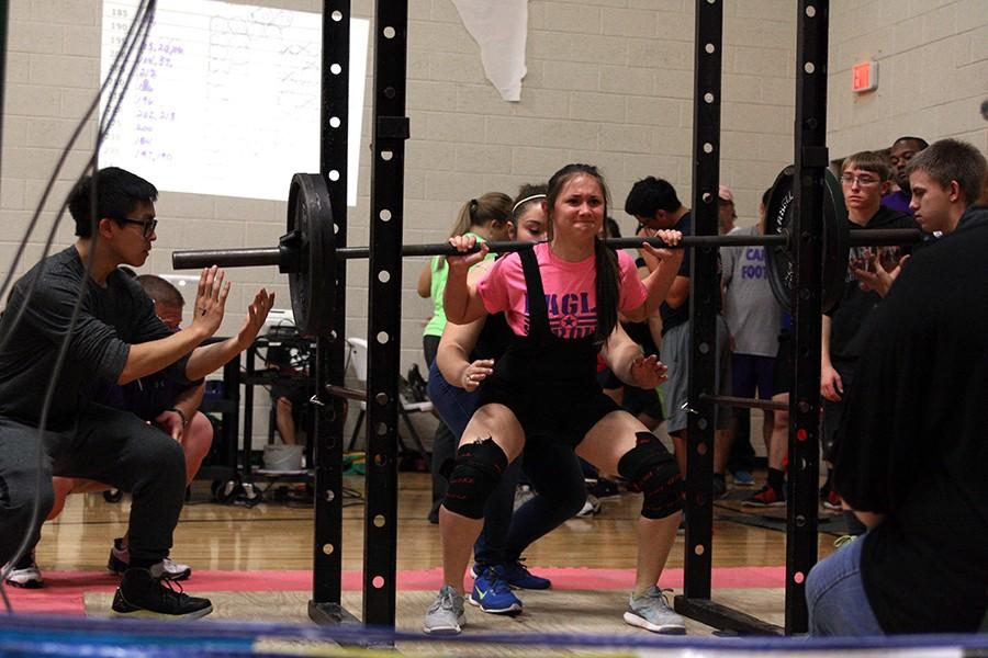 Freshman Brie Mowry begins a squat rep at a powerlifting meet Jan. 30.