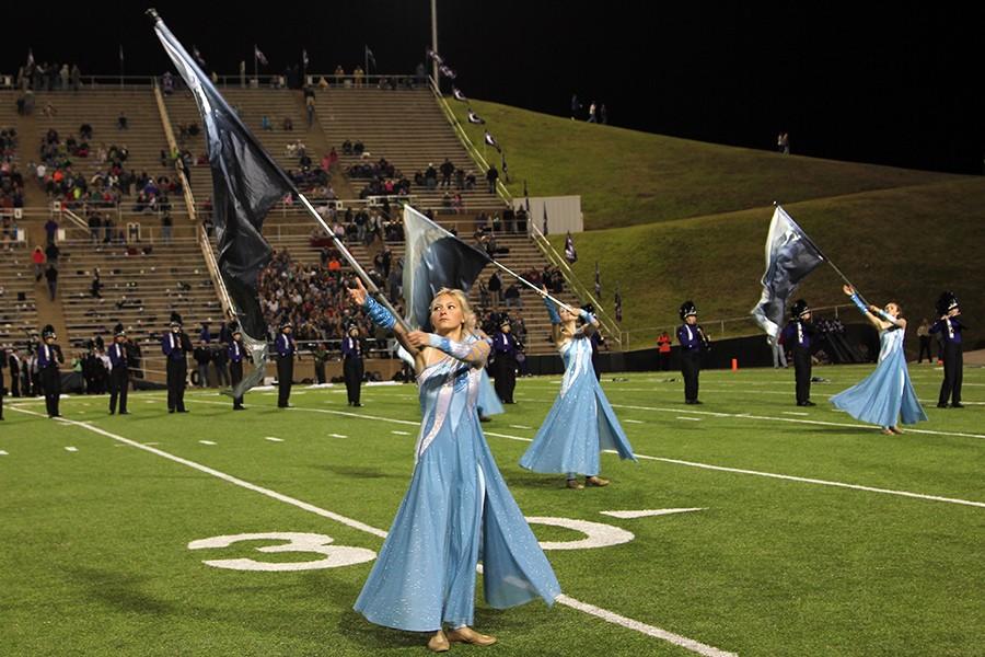 The Colorguard marches with the band Nov. 11 during the halftime show.