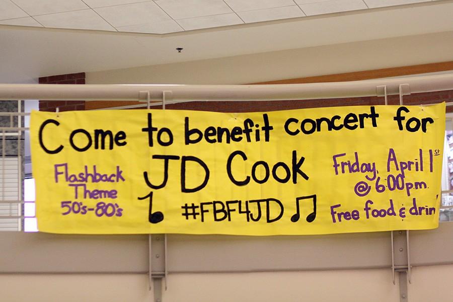 A banner in the commons invites students to attend the benefit concert Friday night.