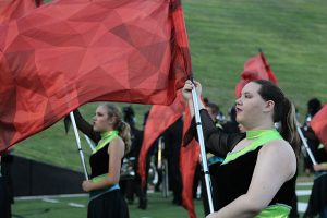Colorguard captains Erica Perez and Rebecca Boehs warm up before halftime