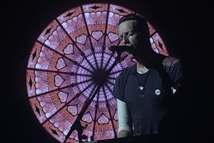 Chris Martin sings and plays piano at the AT&T Stadium.