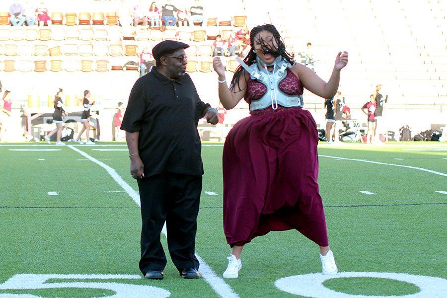 After being escorted by her grandfather, Jimmy Robinson, senior Daisha Ferrell reacts to being named homecoming queen.
