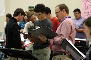 Choir director Brandon Farren works with the bass section on all-region music.