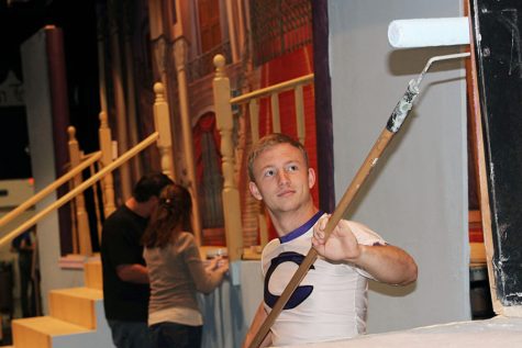 Senior Garrett Brown paints a set piece in preparation for the all-school musical.