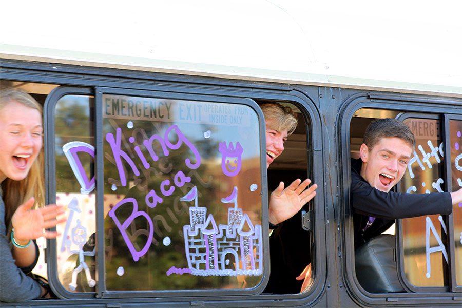 Juniors Ayse Allison and Jack McConnell wave with senior Dylan Knight during the cross country send-off.