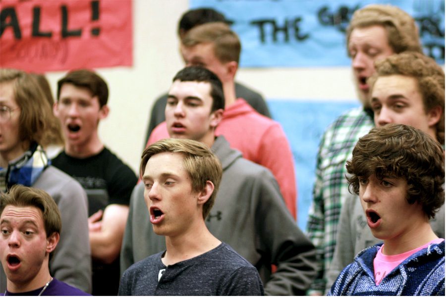 The high school boys choir rehearse their individual piece for Boys Night Out in the choir room.