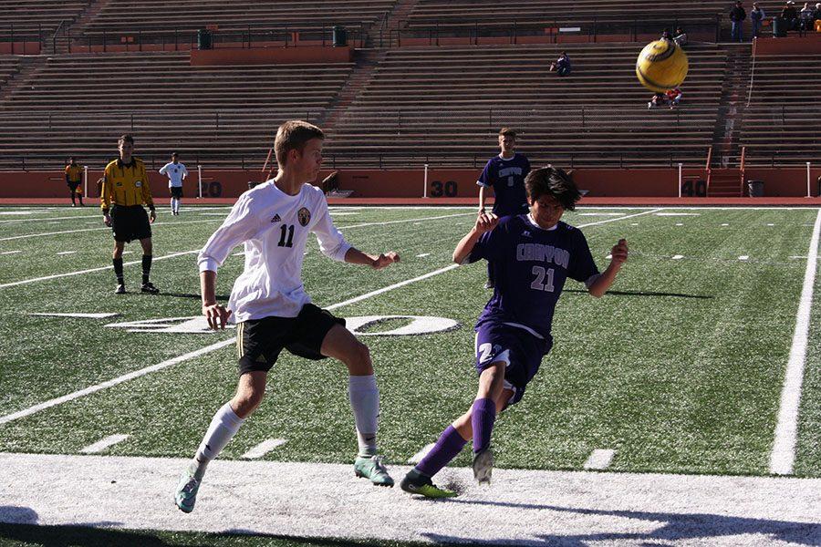 Junior Dilan Negrete, playing right-wing, heads the soccer ball away from an opposing player.