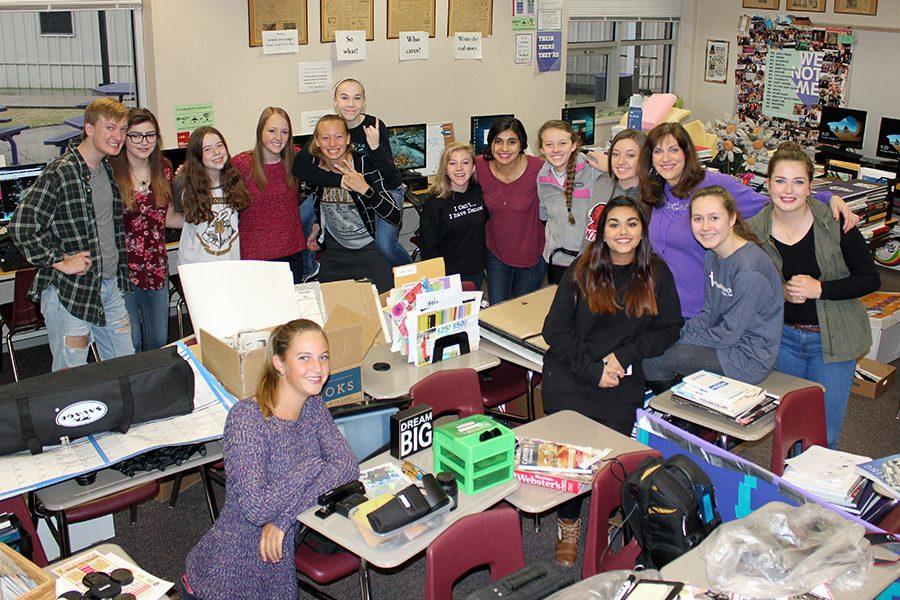 The yearbook staff moved the contents of their entire storage room and photography room along with contents from shelves and wall decor to the center of the room after a roof repair leak caused flooding in the classroom in October. 