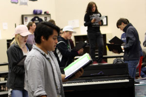 Juniors Nolan Quintanilla and Katelyn Spivey join other choir members practicing audition music  during activity period.