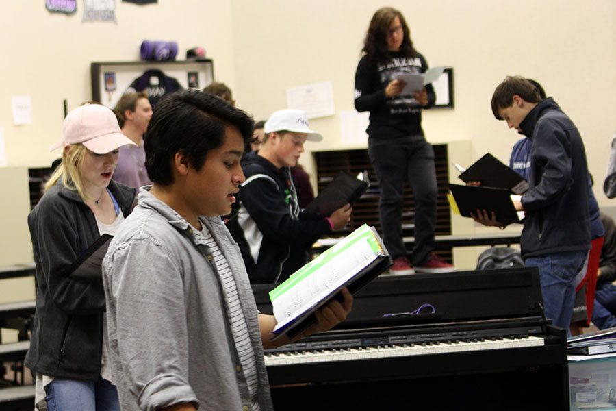 Juniors Nolan Quintanilla and Katelyn Spivey join other choir members practicing audition music during activity period.