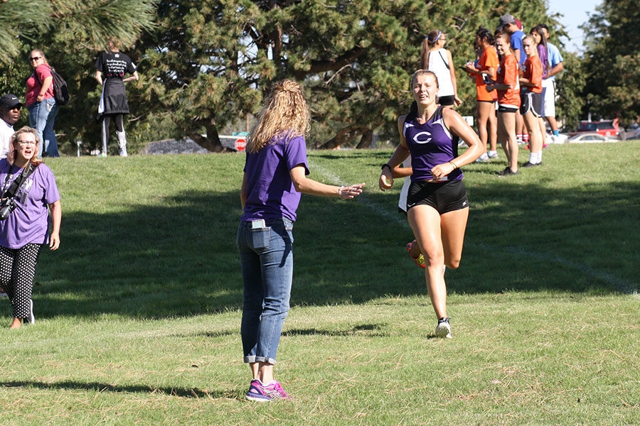 Cheered on by her mother, Sandra Allison, on the far left and Canyon High School counselor Cheryl Hukill, senior Ayse Allison leads her team at the 3-5A District Cross Country Meet in Amarillo Oct. 13.