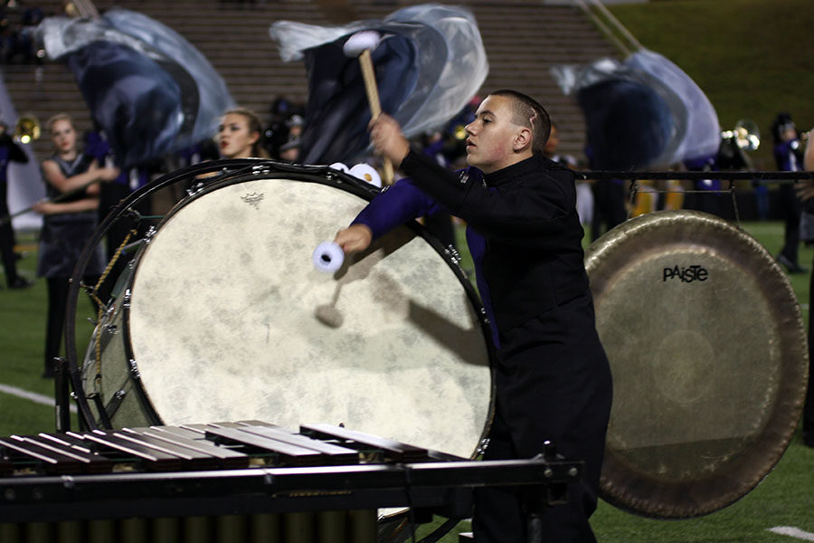 Sophomore Cambry King plays bass drum during the ballad of the bands performance at the football game against Palo Duro.