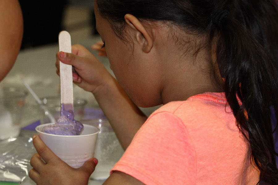 A child conducts an experiment during the 2016 Family Science Night.