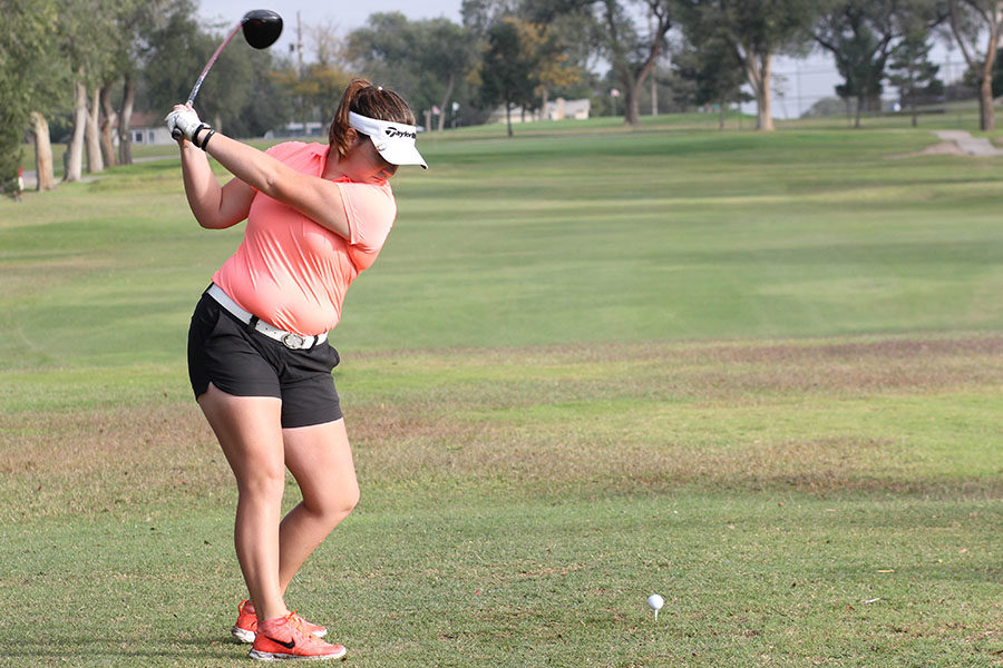 Senior Macy Mitchell hits her driver at the Plainview Triangular in October.