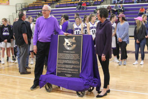 Coach Joe Lombard and his wife Babs celebrate with the plaque for the foyer.