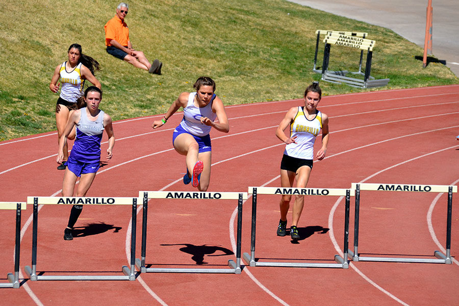 Junior Mackenzie Grimes takes the hurdles at the Amarillo Relays.