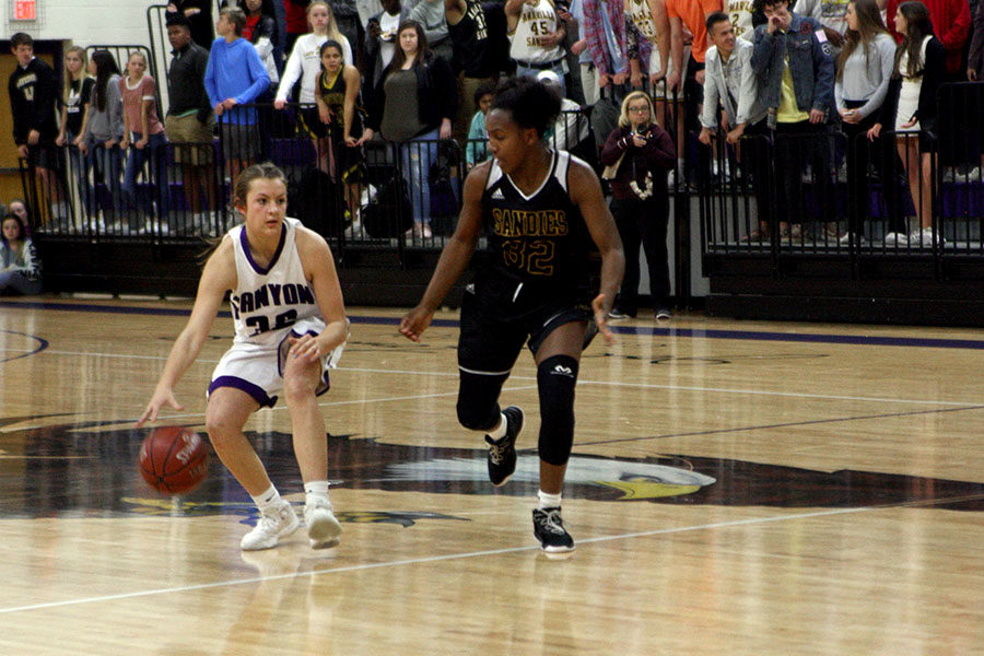 Freshman Kenadee Winfrey dribbles down the court in the Feb. 19 game against Amarillo High, the team they eventually faced in the regional finals.