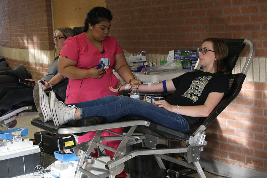 Senior Briann Schenk donates blood during the fall blood drive.