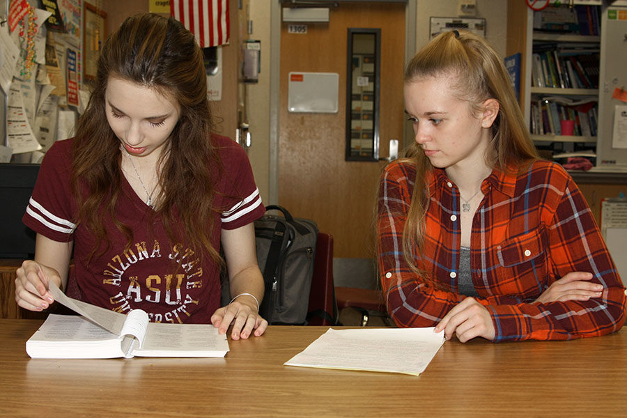 Senior Erin Sheffield and sophomore Macy McClish review an entry in the AP Stylebook as they prepare for the State UIL Academic Meet.