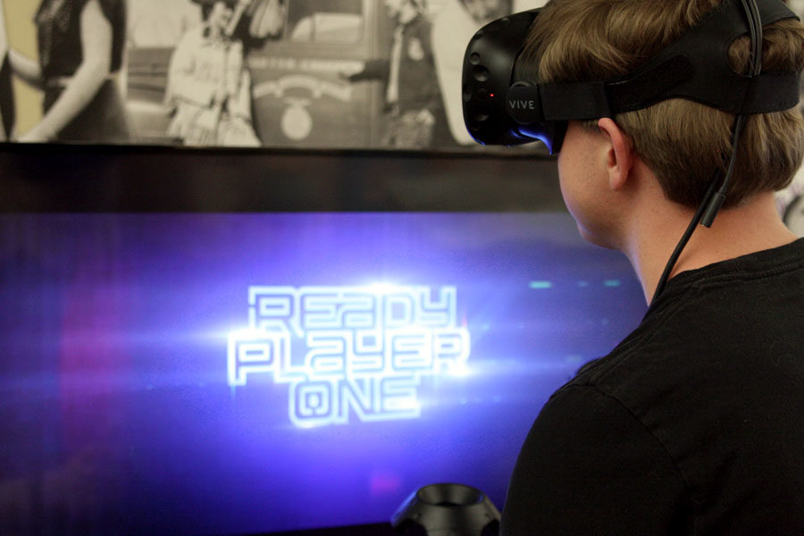 A student watches Ready Player One using virtual reality equipment. 
