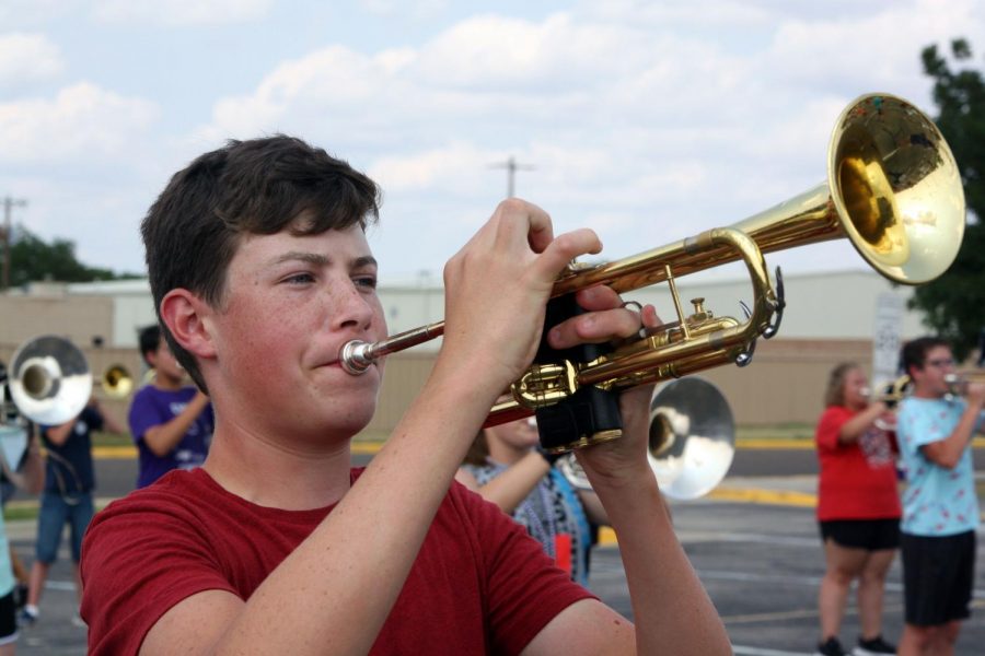 Junior Jacob Douglas plays trumpet during a summer band rehearsal. 