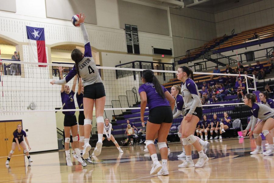 Sophomore+Raylee+Bain+hits+the+ball+back+over+the+net+as+she+plays+with+teammates+Hallie+Lacky%2C+Bryli+Contreras+and+McKenna+Coppock+in+preseason+victory+against+Dalhart.+