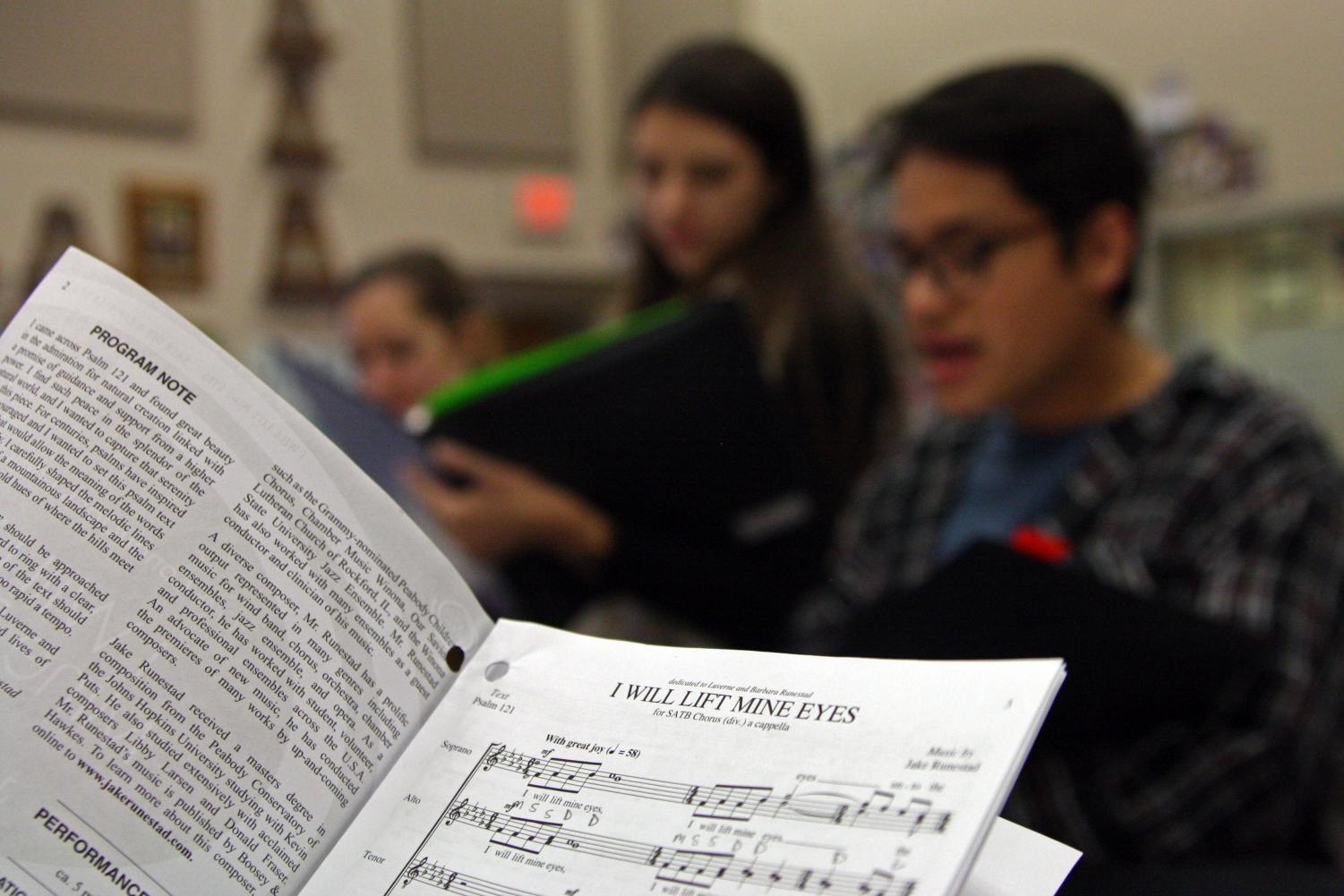 Chamber choir members Krissy Niles, Tori Ross and Nolan Quintanilla review