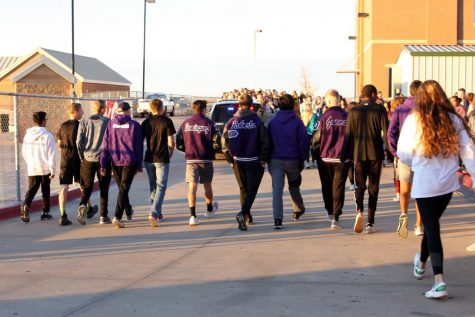 The girls and boys cross country teams leave for the state meet, cheered on by classmates. The boys cross country team is coached by Wesley Kirton. 