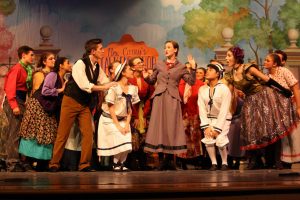 Mary Poppins (Katelyn Spivey) discusses the versatility of the word supercalifragilisticexpialidocious with the customers of Mrs. Corrys (Erin Sheffield) Conversation Shop.